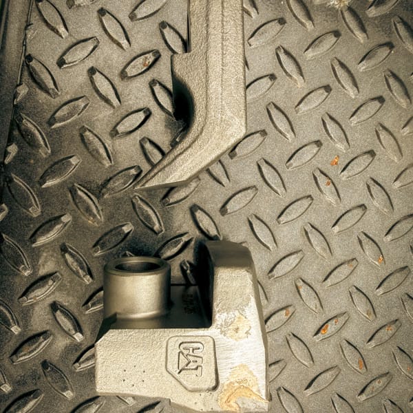 New forestry mulcher knife and carbide cutting tooth side by side.