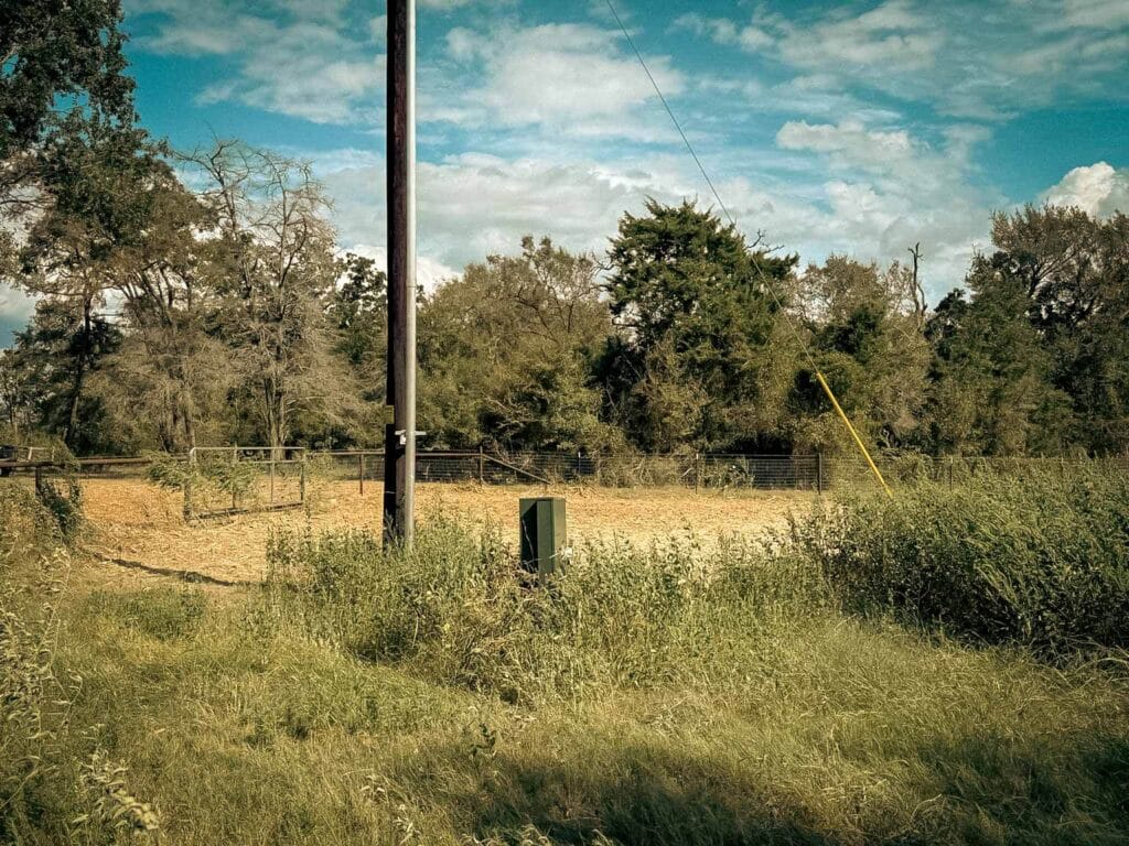 The same utility pole and meter box with the paddock behind them mulched clear, Brazos Valley, TX